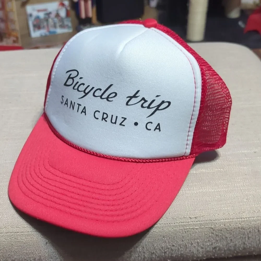 red and white trucker hat featuring text that says 